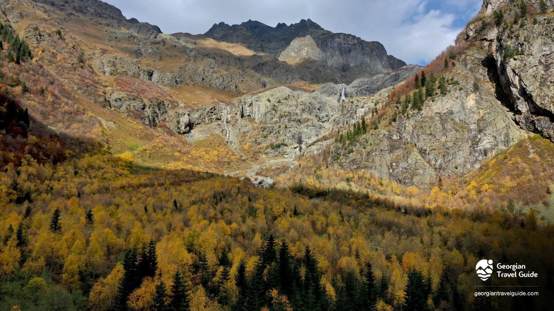 Shot of Ushba Mountains with Ushba Waterfall in th middle